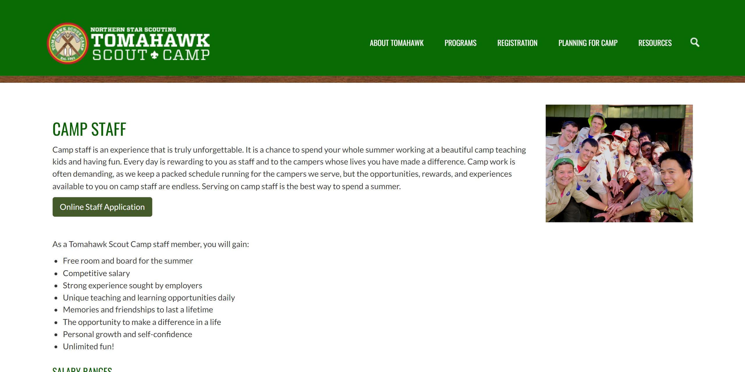 An article on the Camp Tomahawk website talking about camp staff. The navigation bar from before is still present, then the main article is shown along with an image of a group of camp staff with their hand together off to the right.